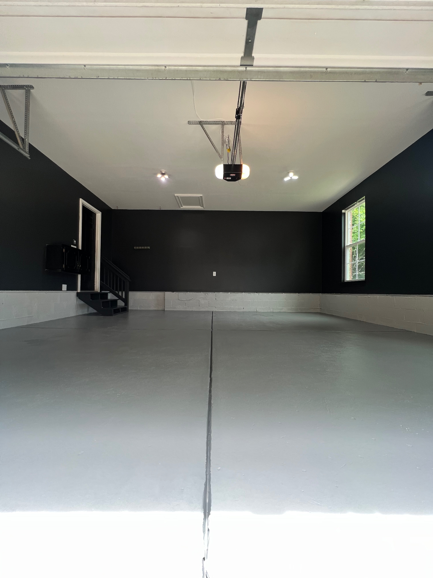 Garage transformation — bold black walls & sealed floor