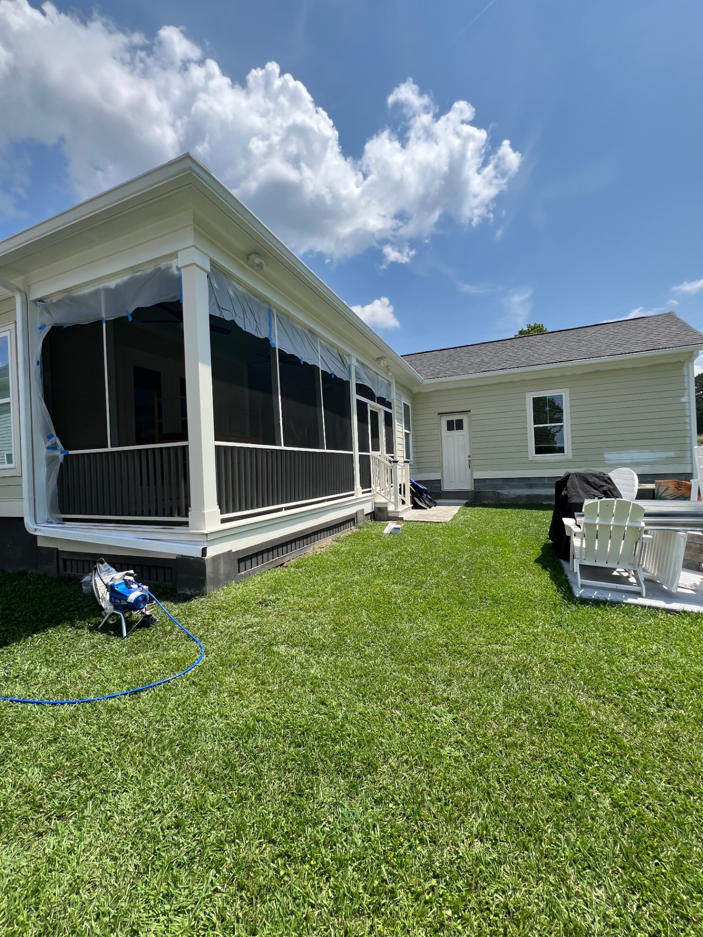Exterior spray in progress — masked & prepped