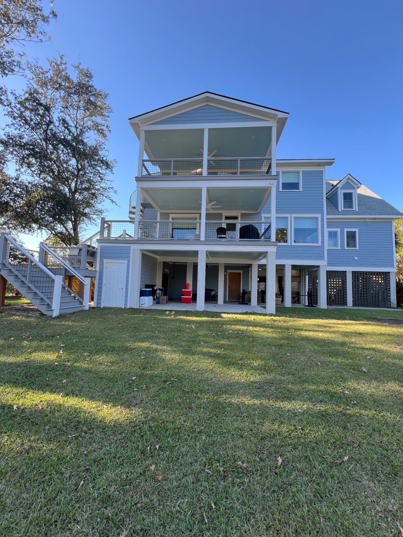 Three-story blue coastal home by Gonzalez D Painting
