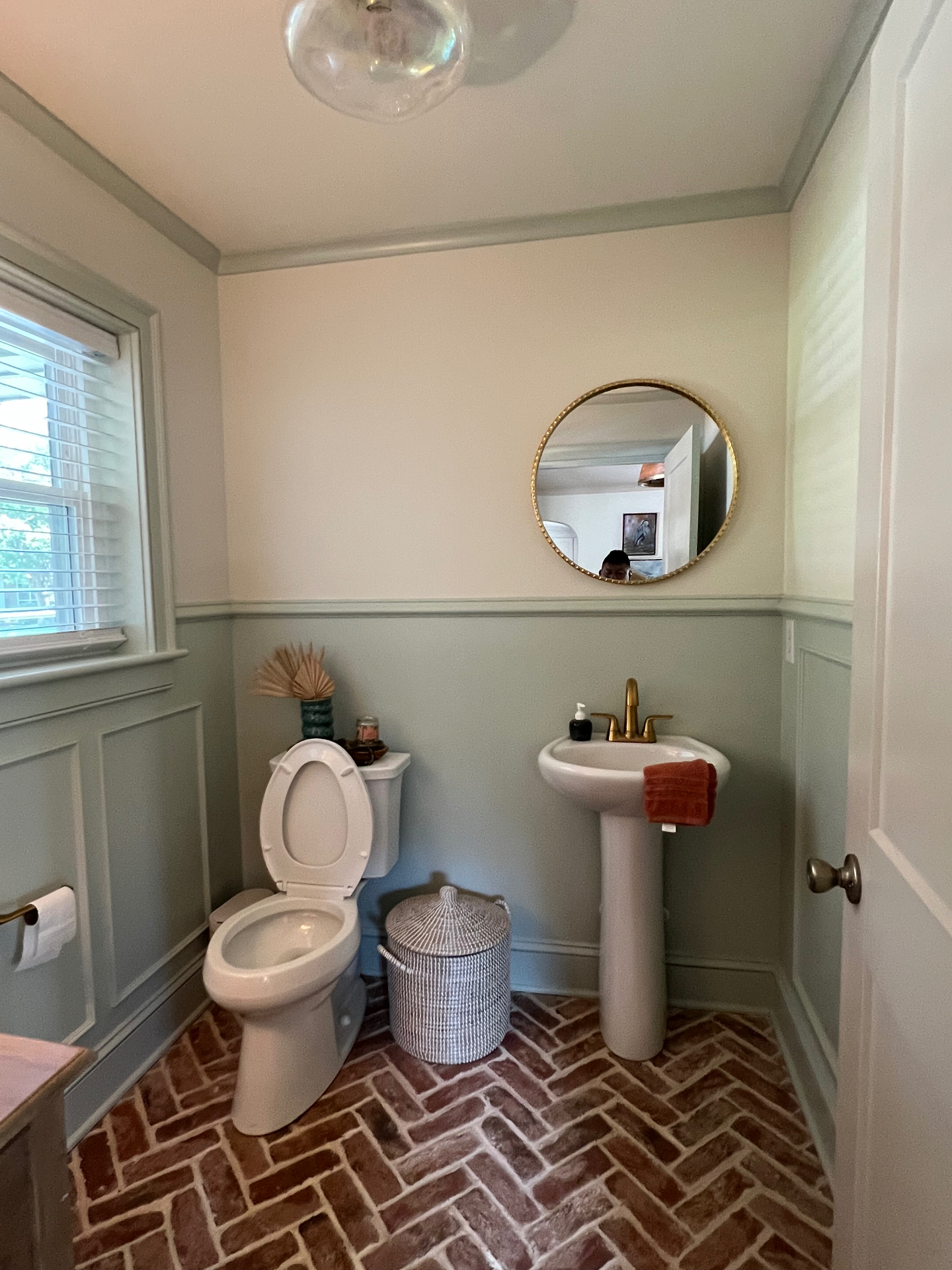 Powder room finish with panel molding and painted trim